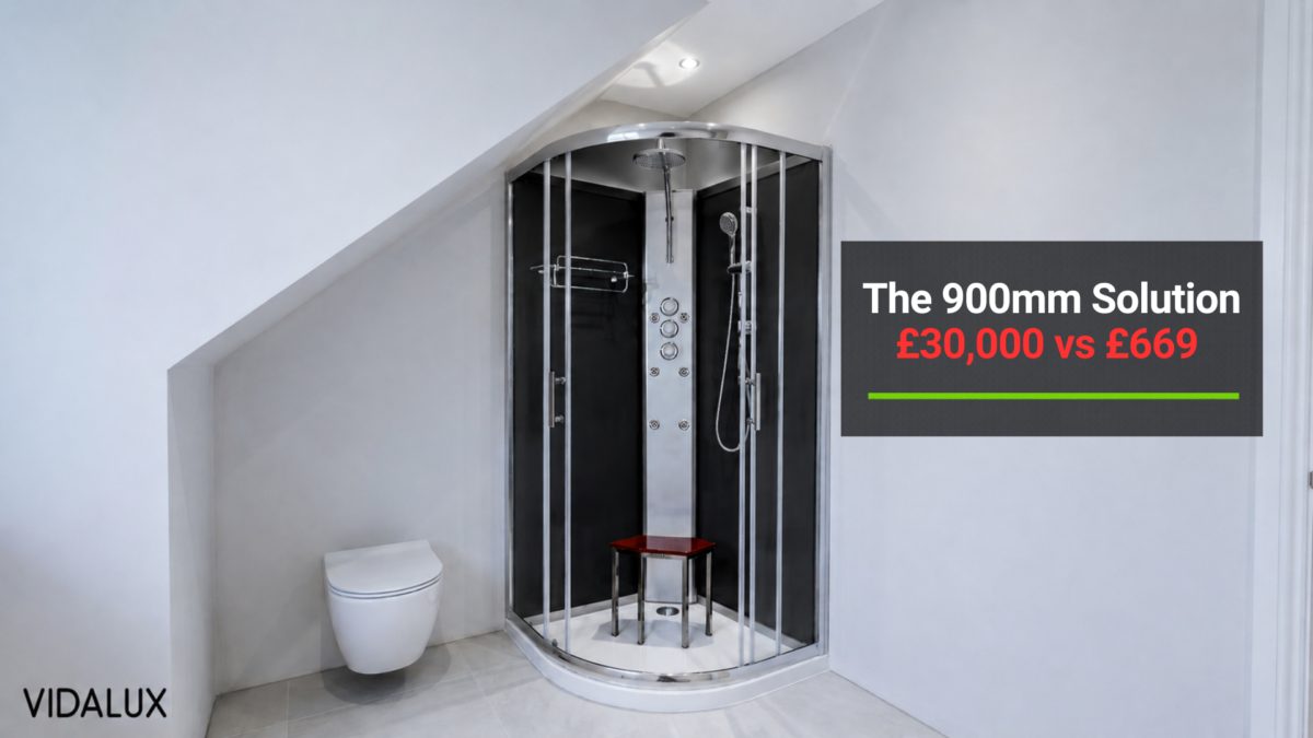 Pure 900 quadrant hydro shower cabin in white finish installed in a tight UK understairs cloakroom, with the angled understairs ceiling visible above the cabin and a wall-hung WC alongside, demonstrating the 2,300mm minimum ceiling clearance.